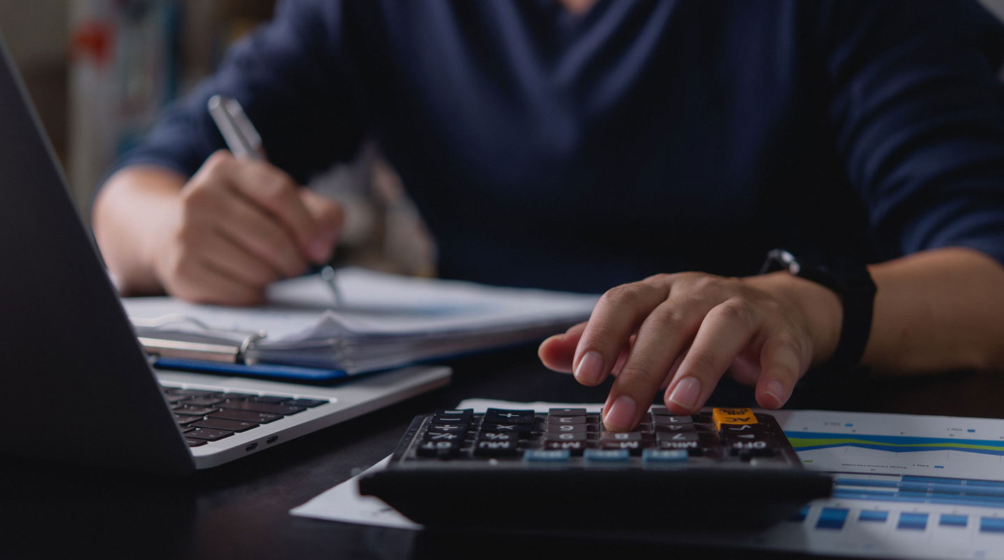Responsable administratif analysant un tableau de calculs pour le dimensionnement des bonbonnes selon l'effectif